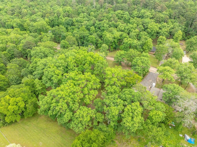 aerial view of property's location featuring a heavily wooded area