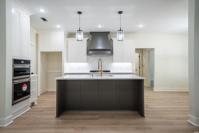 135 Ridgeway Pl, Hot Springs, AR 71901 - kitchen with wall chimney range hood, double oven, white cabinets, and recessed lighting