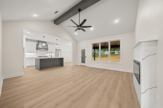 135 Ridgeway Pl, Hot Springs, AR 71901 - unfurnished living room featuring a glass covered fireplace, a ceiling fan, light wood-style flooring, recessed lighting, and a sink