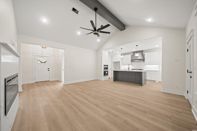 135 Ridgeway Pl, Hot Springs, AR 71901 - unfurnished living room with a ceiling fan, light wood-style flooring, recessed lighting, a tiled fireplace, and baseboards