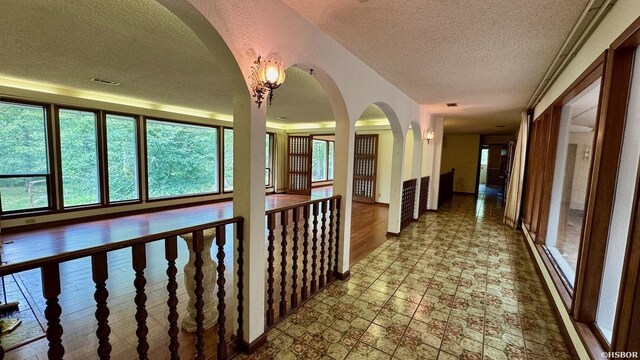 corridor with a textured ceiling and visible vents