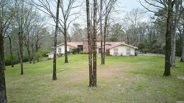 view of front facade with a front yard and stucco siding