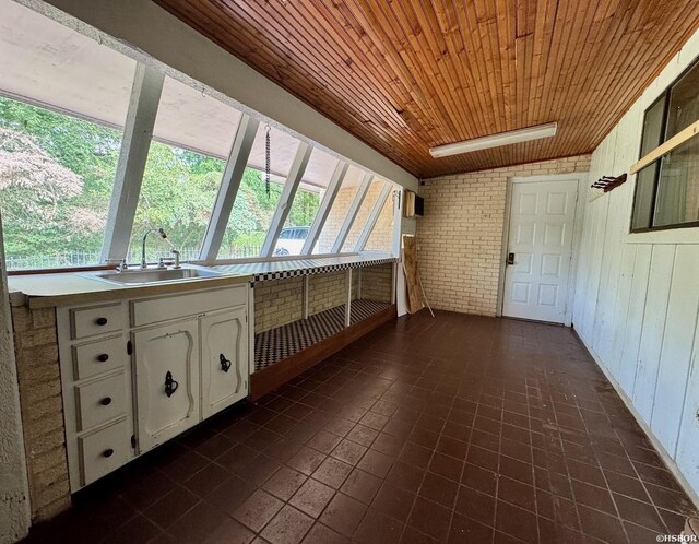 unfurnished sunroom with a sink and wood ceiling