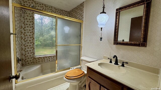 full bath featuring toilet, wallpapered walls, enclosed tub / shower combo, and vanity