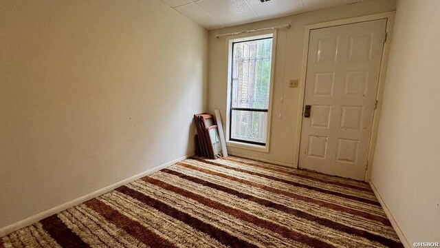 entryway featuring carpet floors, radiator, and baseboards