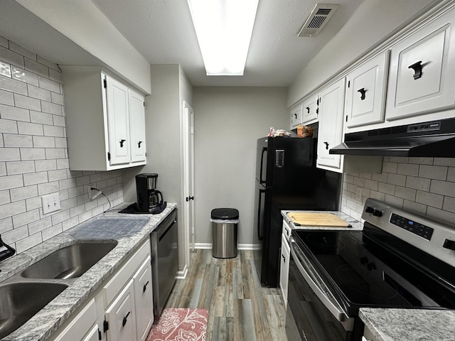 kitchen featuring under cabinet range hood, white cabinetry, visible vents, and stainless steel electric stove