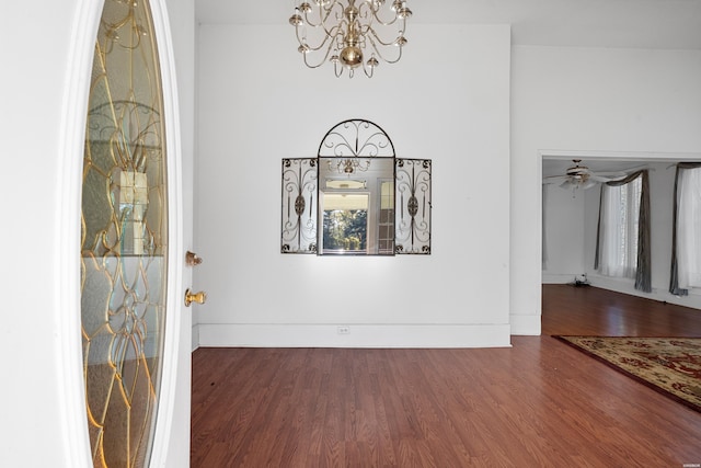 entryway with baseboards, dark wood-style flooring, and a notable chandelier