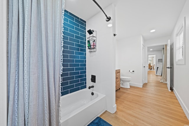 full bath featuring baseboards, wood finished floors, vanity, and shower / tub combo with curtain