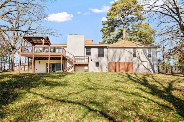 back of house with brick siding, a lawn, a chimney, and a wooden deck