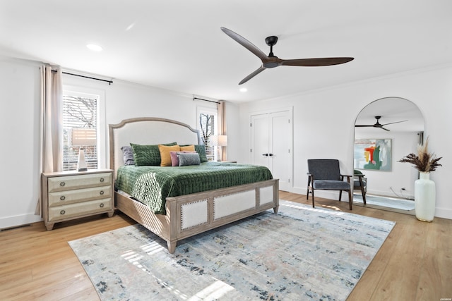 bedroom featuring light wood-style floors, ceiling fan, and baseboards