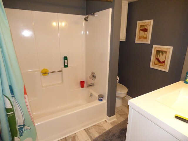 bathroom with shower / bath combo, vanity, and toilet