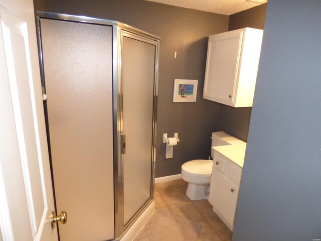 full bath featuring a textured ceiling, tile patterned flooring, toilet, vanity, and a stall shower