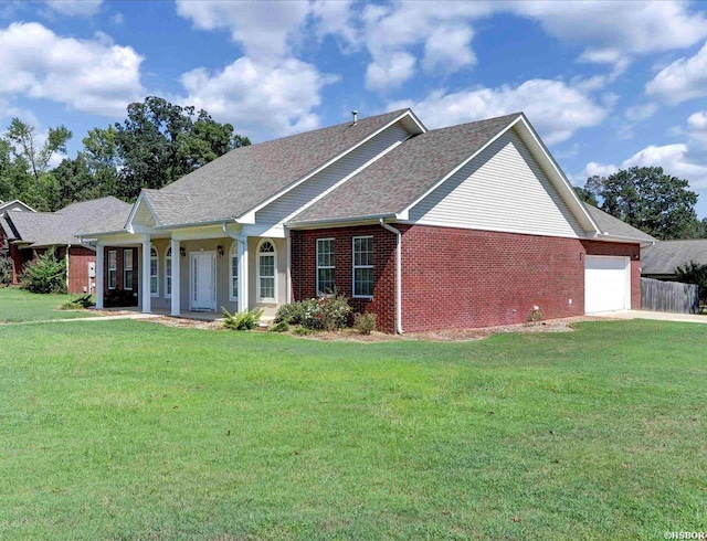 single story home featuring a garage, roof with shingles, a front lawn, and brick siding