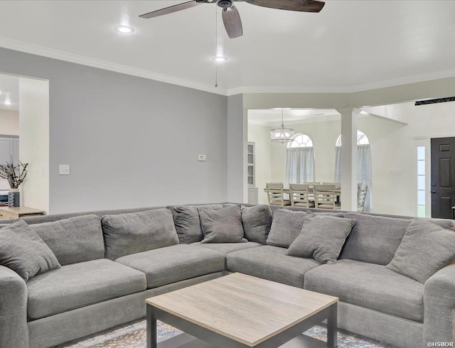 living area with ceiling fan with notable chandelier, ornamental molding, and recessed lighting