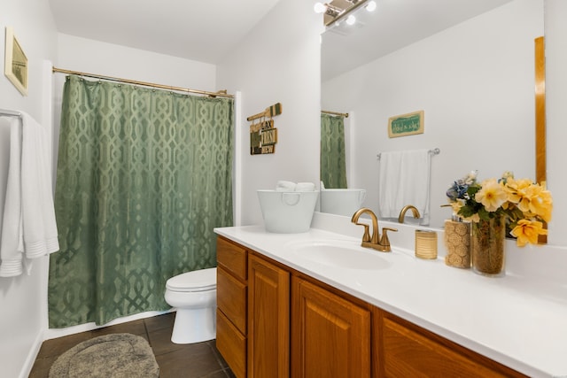 bathroom with tile patterned flooring, vanity, and toilet