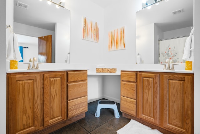 bathroom featuring tile patterned flooring, visible vents, and vanity