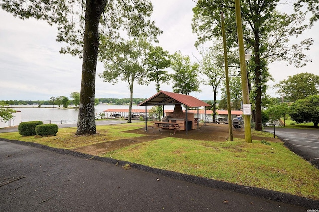 view of home's community with a lawn and a water view