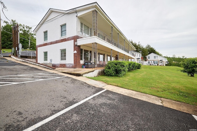 view of building exterior featuring uncovered parking