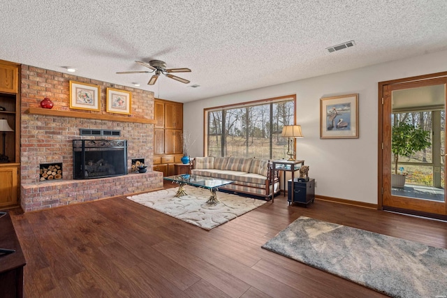 living room featuring wood finished floors, plenty of natural light, and a fireplace