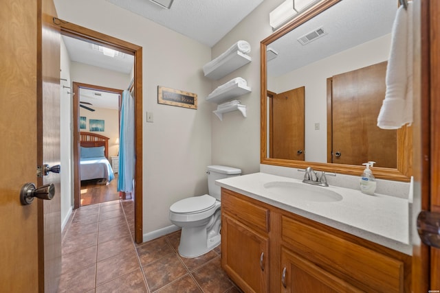 ensuite bathroom with tile patterned flooring, toilet, connected bathroom, vanity, and visible vents