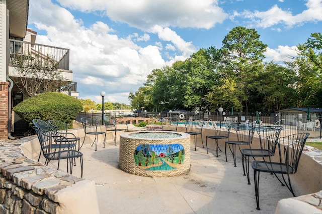 surrounding community featuring a hot tub, fence, a pool, and a patio