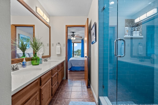 ensuite bathroom with a textured ceiling, tiled shower, ensuite bath, and a sink