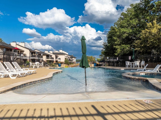 pool featuring a patio area and fence