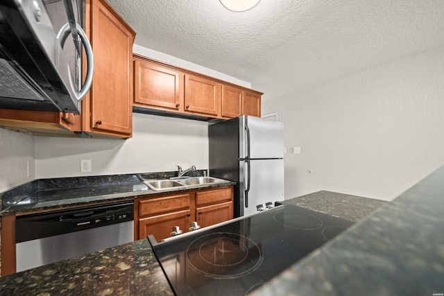 183 River Mill Ct Unit B-1, Hot Springs, AR 71913 - kitchen with stainless steel appliances, brown cabinetry, dark stone countertops, and a textured ceiling