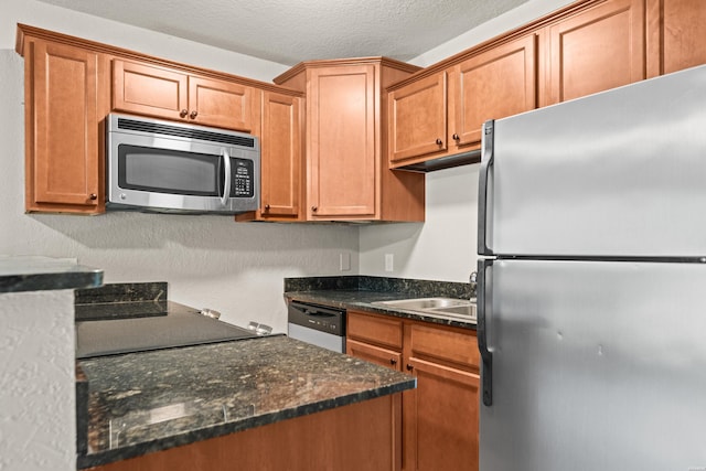 183 River Mill Ct Unit B-1, Hot Springs, AR 71913 - kitchen with stainless steel appliances, brown cabinets, and a textured ceiling