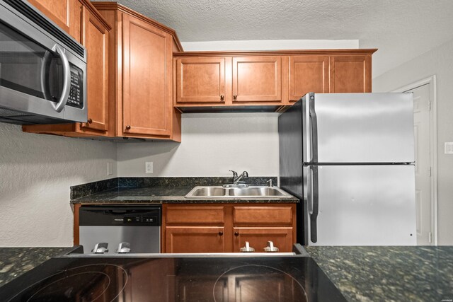 183 River Mill Ct Unit B-1, Hot Springs, AR 71913 - kitchen featuring appliances with stainless steel finishes, brown cabinetry, and dark stone countertops