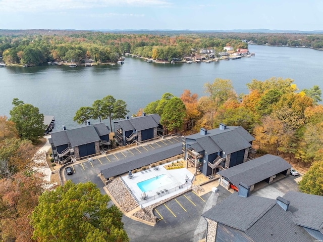 drone / aerial view with a water view and a wooded view