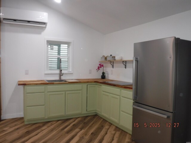 1010 Greenwood Ave Unit & 101Peculiar, Alley, Hot Springs, AR 71913 - kitchen with freestanding refrigerator, wood counters, a wall unit AC, green cabinets, and a sink