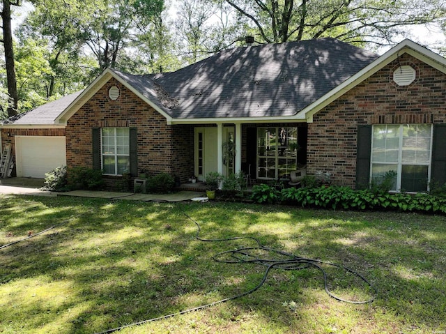 ranch-style home with a garage, brick siding, and a front lawn