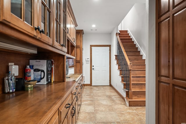 entrance foyer with stairway, baseboards, and recessed lighting