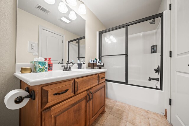 full bath with shower / bath combination with glass door, vanity, visible vents, and tile patterned floors