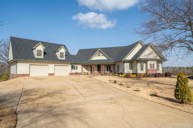 view of front facade featuring a garage, driveway, a porch, and a shingled roof