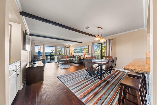 dining area featuring ornamental molding, dark wood-type flooring, and a healthy amount of sunlight