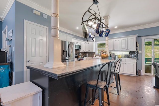114 Cliffwood Loop, Hot Springs, AR 71913 - kitchen featuring stainless steel appliances, tile countertops, a kitchen bar, white cabinetry, and crown molding