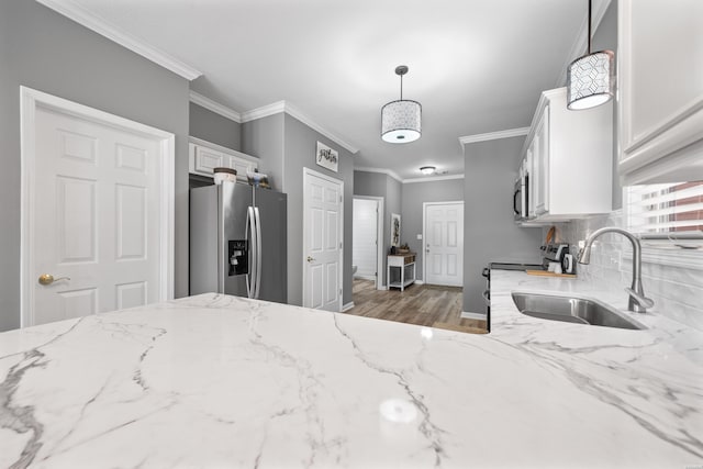 128 Kaleigh Ct Unit B, Hot Springs, AR 71913 - kitchen featuring appliances with stainless steel finishes, a sink, white cabinets, light stone countertops, and ornamental molding