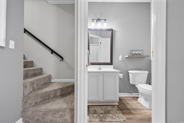 128 Kaleigh Ct Unit B, Hot Springs, AR 71913 - half bathroom featuring toilet, vanity, wood finished floors, and baseboards