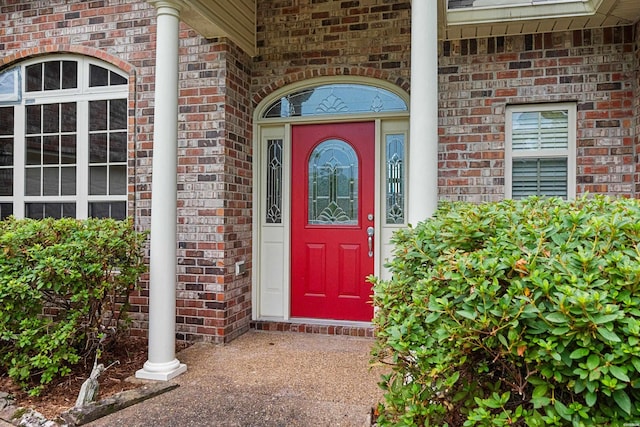 doorway to property with brick siding