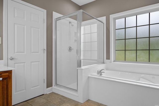bathroom featuring tile patterned floors, a shower stall, vanity, and a bath