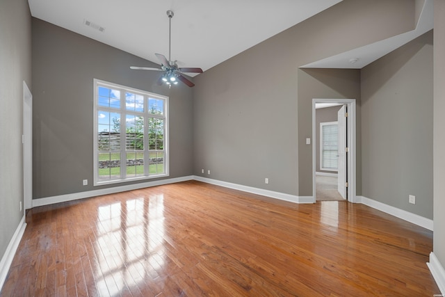 unfurnished room with light wood-style floors, baseboards, and visible vents