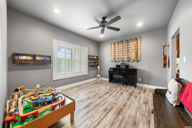 playroom with recessed lighting, wood finished floors, a ceiling fan, and baseboards