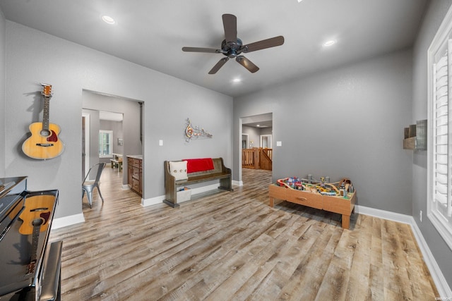 bedroom with multiple windows, recessed lighting, wood finished floors, and baseboards