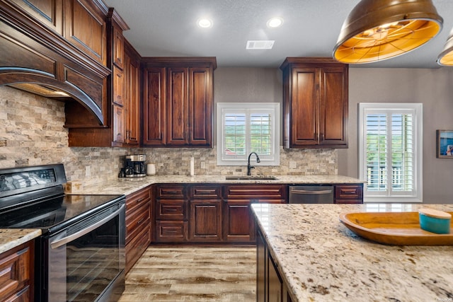 kitchen featuring visible vents, black range with electric stovetop, decorative backsplash, a sink, and dishwasher