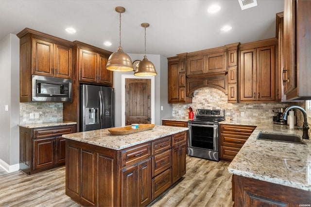 kitchen featuring light wood-style flooring, visible vents, stainless steel appliances, and a sink