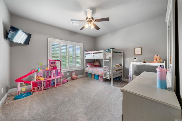 carpeted bedroom with a ceiling fan, visible vents, and baseboards