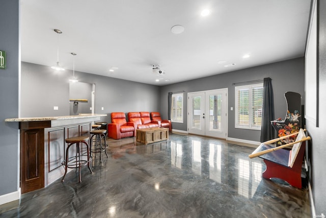 living area featuring recessed lighting, baseboards, french doors, a bar, and finished concrete floors