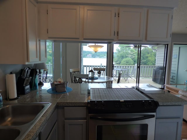 400 Farr Shores Dr Unit 2E, Hot Springs, AR 71913 - kitchen with gas stove, a sink, white cabinetry, and tile counters